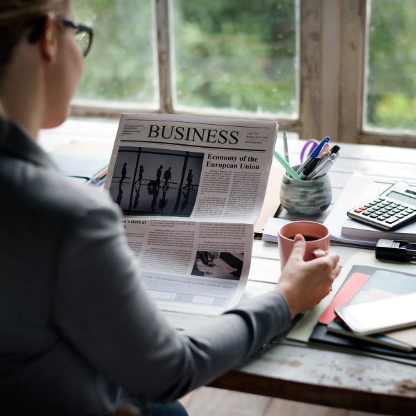 businesspeople-reading-newspaper-at-office-updating-news.jpg